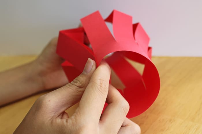 Once you have cut the paper for your Chinese lantern, open it up and bring the ends together to make a circle.
