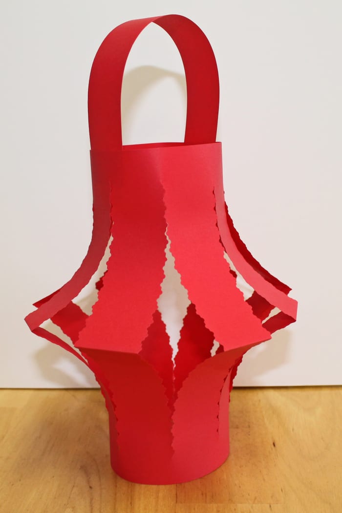 Here is a variation on the simple Chinese paper lantern. Use decorative edging scissors to cut the lantern strips.