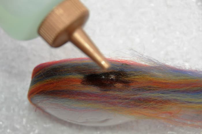 Use the squeeze bottle to add a few drops of water to help ensure that the fibers stick to the soap