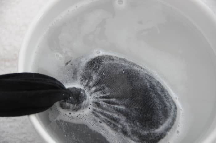 Dip into a bowl of very hot water once the felted soap has been removed from the tumble dryer
