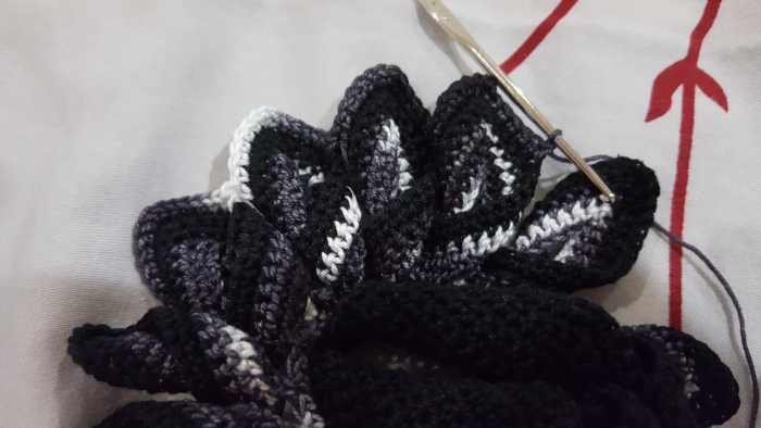 Twist the next point when you reach it to ready it for the next set of stitches. This picture contains more points with their stitches completed. They are laying flat and have the chevron pattern.