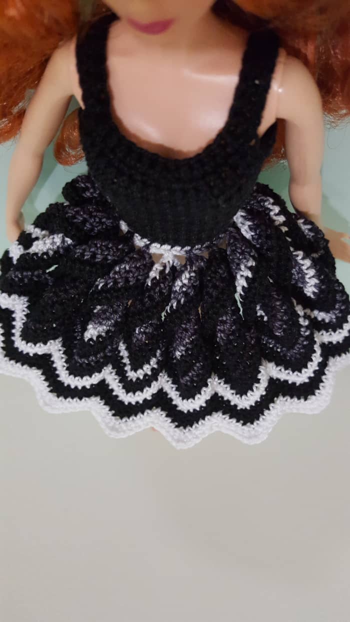 The skirt "fully" opened. I prefer the skirt to have a smaller opening compared to a full-fledged doily, so the chevron Rounds have decreasing stitch counts instead of increasing.