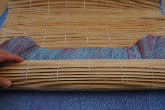 Roll up inside a bamboo mat. Change the direction in which you roll it, several times as shown in the next images.