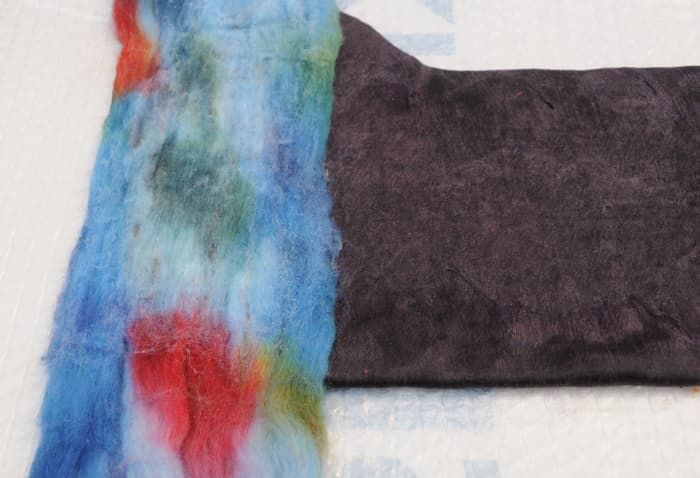 Place the opened up wool roving across the width or the length. Wet, turn over the repeat on both sides.