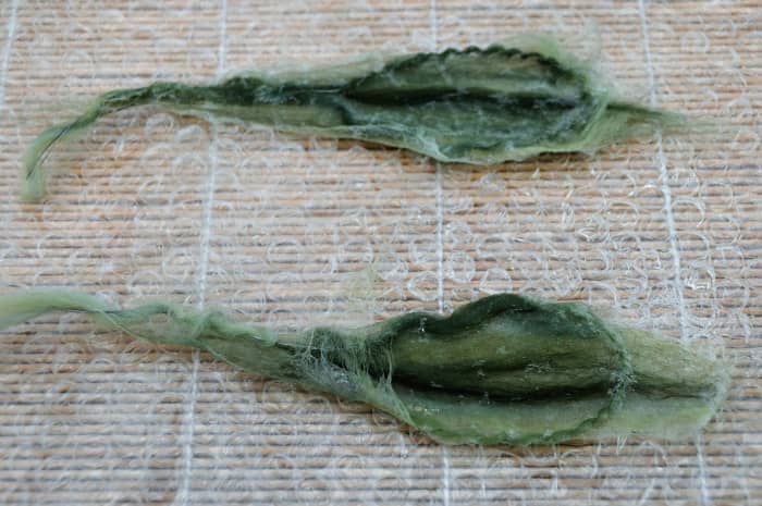 Neaten the edges by folding them over the wire and then put back under the bubblewrap