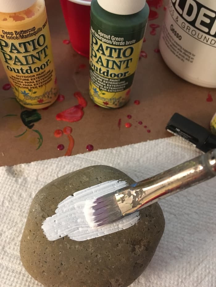 I gessoed the tops of my stones, which helps the color to go on more evenly. It also helps to make light colors, like yellow, more visible on the stones.