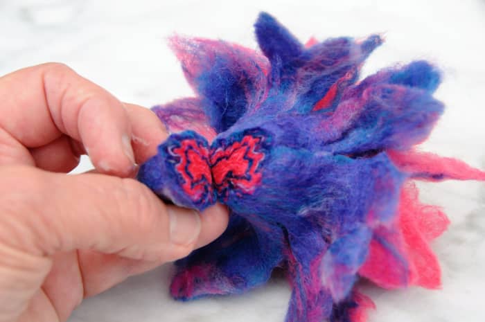 You might like to cut off the bottom of the flower in order to glue it onto a brooch pin as shown.