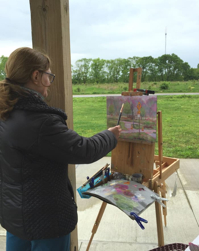 Me again painting outdoors on a cold and rainy day. Finding shelter with a decent view became essential on that outing. The image source link is to my blog post "Painting Outside Is Always a Challenge, but So Much Fun!"
