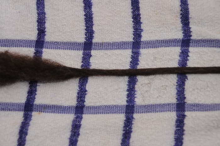Rub more firmly and the dreadlock will narrow and become firmer under your fingers.