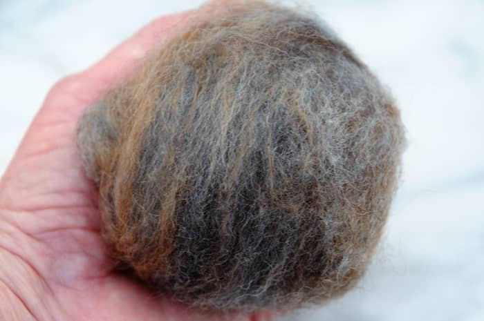 Compress the oddments of wool roving into a tight ball about the size of an open hand.