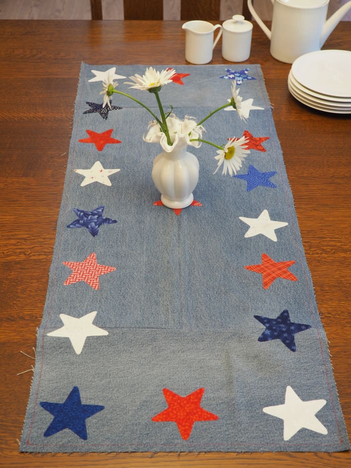 Easy tutorial for a festive DIY table runner made with repurposed blue jeans and fabric scraps.