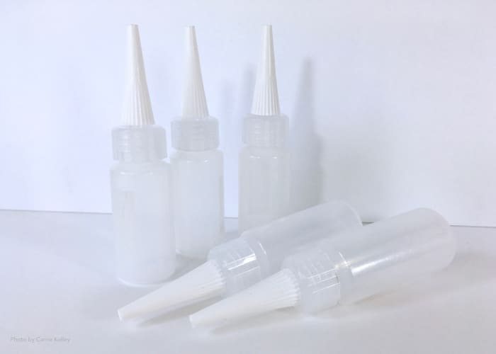 Plastic squeeze bottles can be filled with your paint and medium mixture and used to create additional designs in your piece.