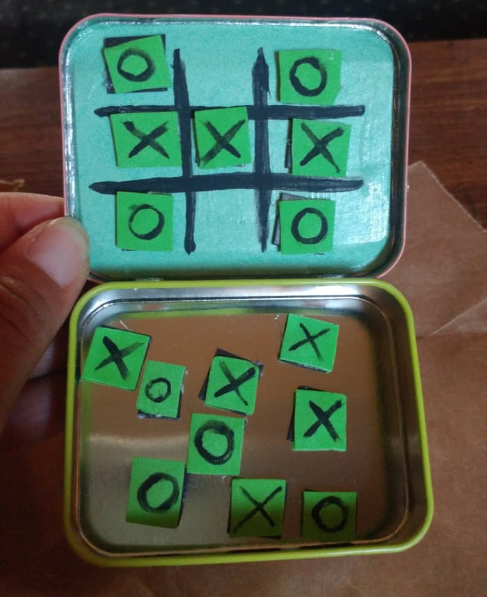 The little squares can be kept inside tin. The squares will stay on the lines during a game, because of the magnets.
