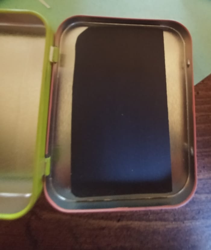 Stick magnet strips onto the inside of the lid. Strips should be stuck down the middle, be sure that tin is still able to close.