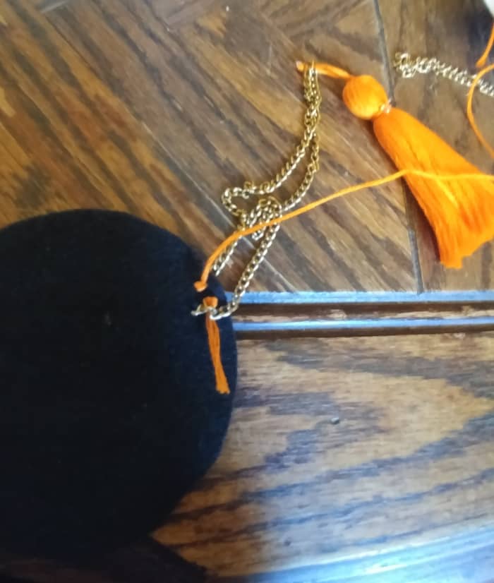 Sew the other end of chain on the felt circle. Right behind and next to the other end of sewn chain.