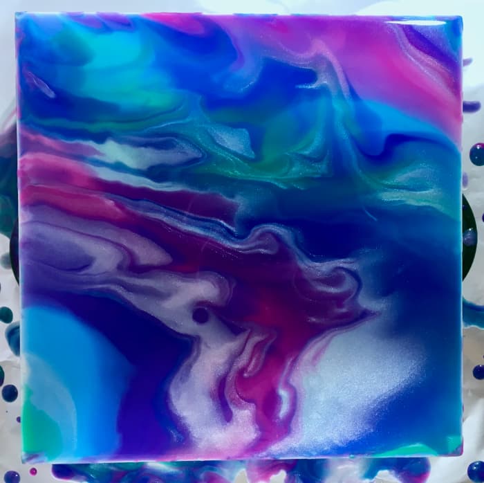 This is the painting after it was tilted. The colors have blended together and look more muted because some of the ink has spilled over the sides.