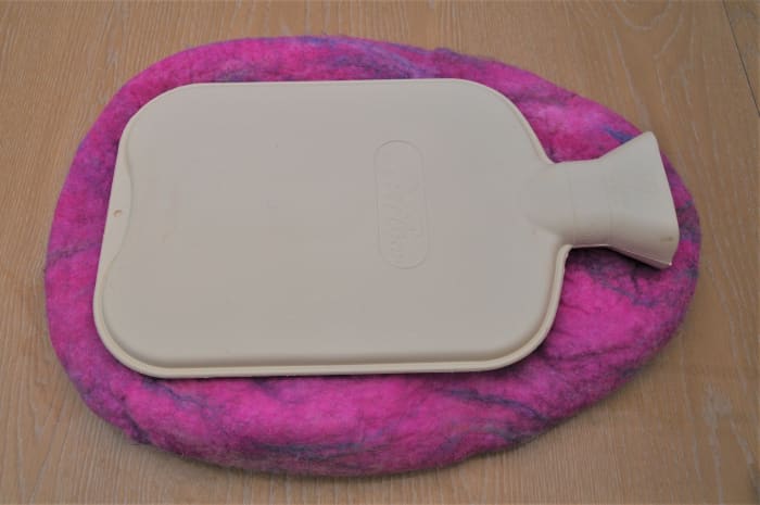 Pop the project into a tumble dryer. Check every five minutes to see if it has shrunk to the desired size.