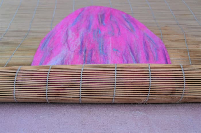 Roll the project loosely inside a large bamboo blind. Roll very gently at first so as not to displace the fibers.
