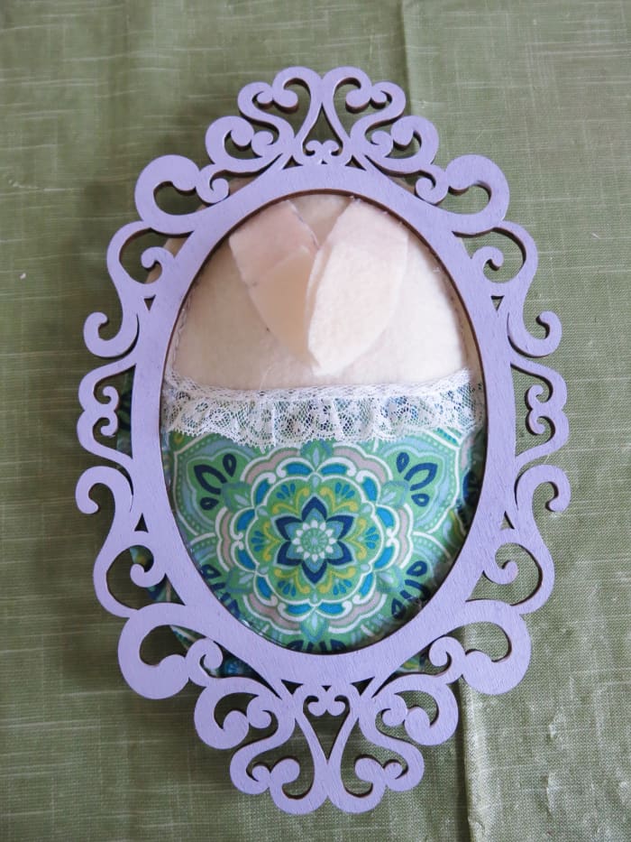 Attach your frame over your bunny's body with the ears still folded over the face.