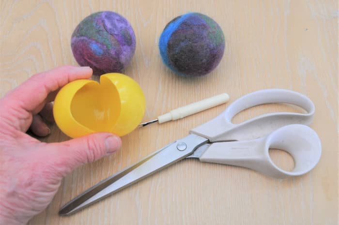 To make small balls, use plastic water play balls which should be cut open as shown. Leave a quarter of the ball intact.