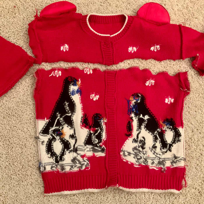 Design is centered and all seams are closed on this button front sweater. Leave a side open if you have a pullover sweater.