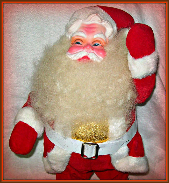 This vintage Santa measures about 14 inches tall. He is in his red velvet suit, with white trim, belt and boots. He is wearing a gold shirt under his coat.
