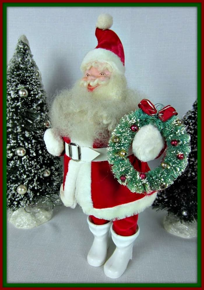 Red Velvet Suit, trimmed in plush. Original white vinyl belt. Woolly beard, mustache, and eyebrows. Hand Painted Face. Cheerful expression. Wearing original white boots. Standing approximately 16" tall to tip of cap.