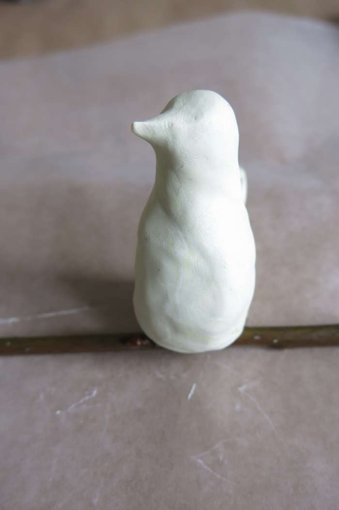Putting the finishing touches on your decorative clay bird