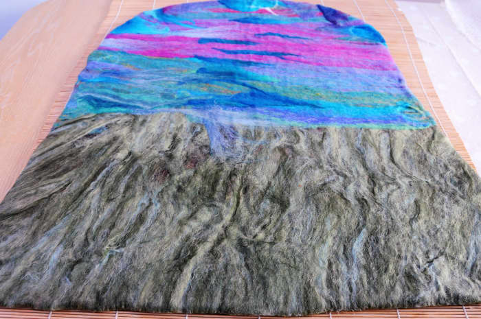 The 1st layer on both sides completely covered with wool roving. This side will become the inside of the hat.