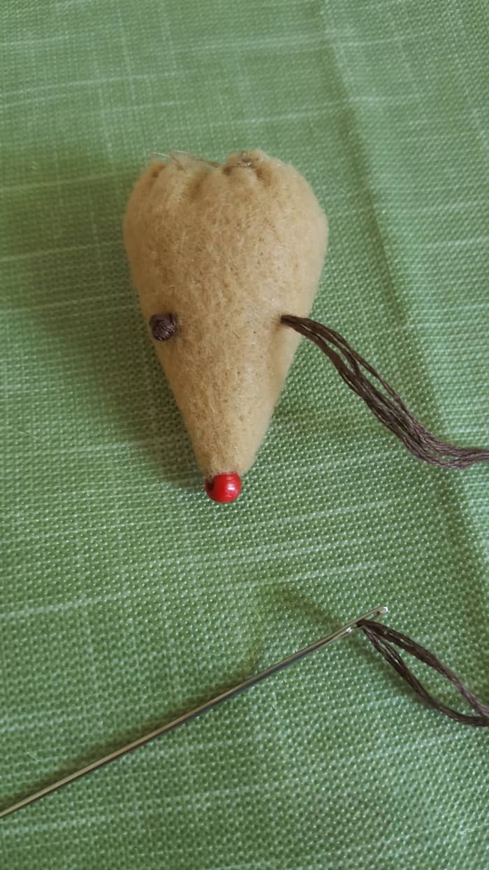 Create the mouse's eyes with embroidery floss. Alternately, you can use beads, googly eyes, or whatever else you choose.