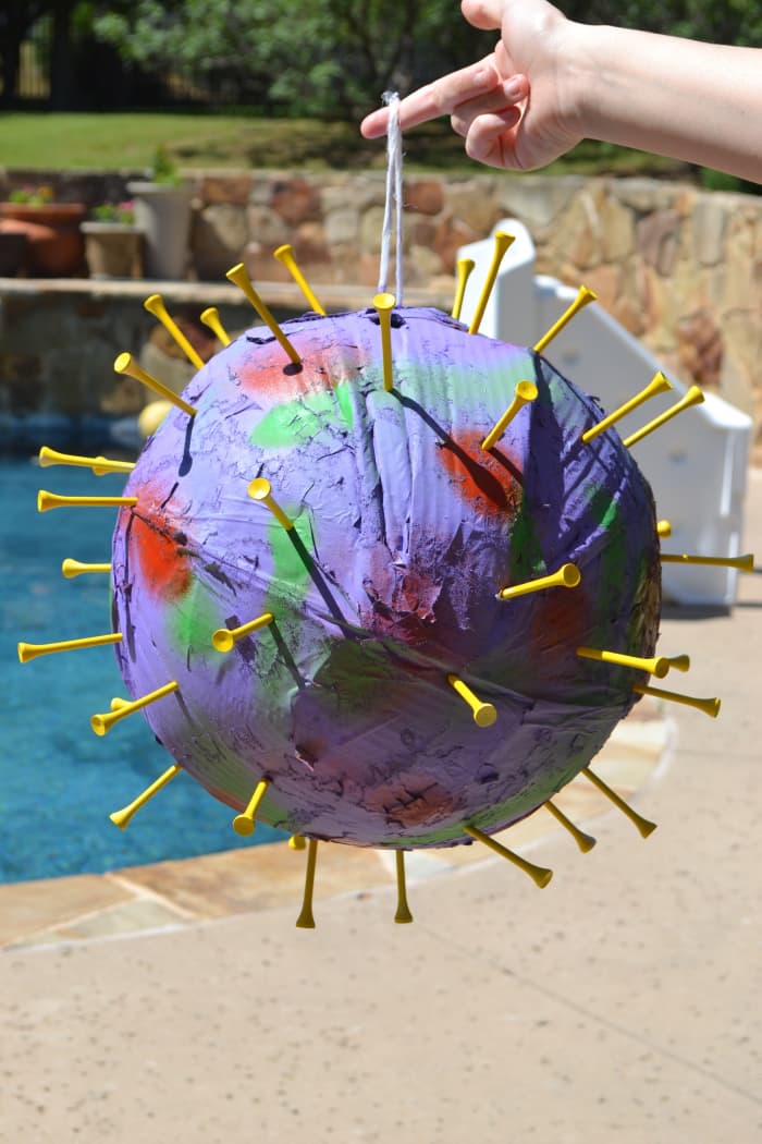 Even without the pompoms, the pinata is starting to resemble a COVID-19 virus model.