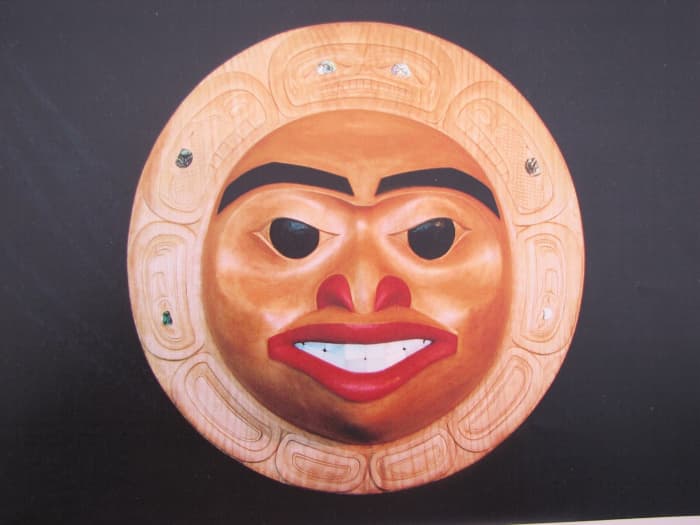 Moon Mask-Gitxsan Wetsuweten-style carving. Note the flatter flowing planes and the sparser painting using mainly black and red accent colors with carved formline design and inlay.