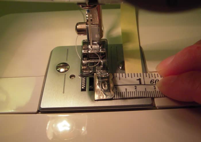 Measure from center needle position to find the footplate marking that corresponds to the 5/8" seam allowance. You can put masking tape or other colorful reminder onto the footplate along the 5/8" mark to act as a reminder.