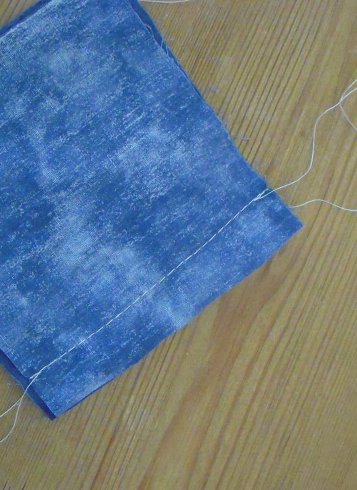 This shows what a seam looks like after it is sewn. It uses reversed stitches at each end to "lock" the seam. It has a 5/8" seam allowance. Now it is ready to be pressed open.