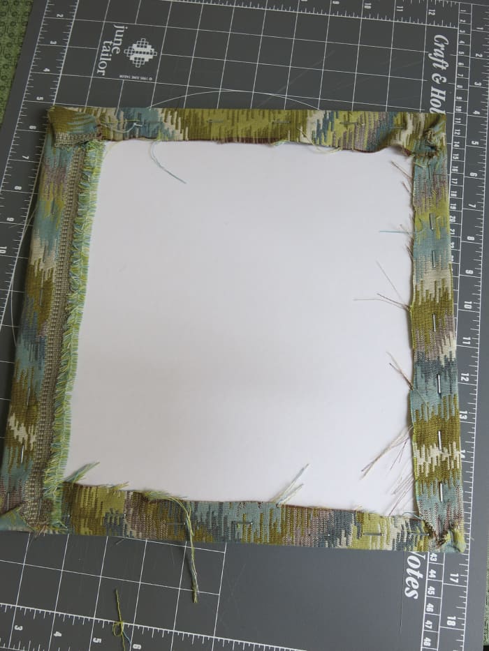 staple your fabric on all sides, making sure that it looks smooth and tight from the front of your bulletin board