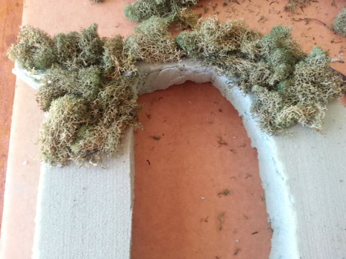 Slowly covering the Styrofoam letter with moss. It looks pretty rough in the beginning, but do not lose heart, for it will shape up nicely.