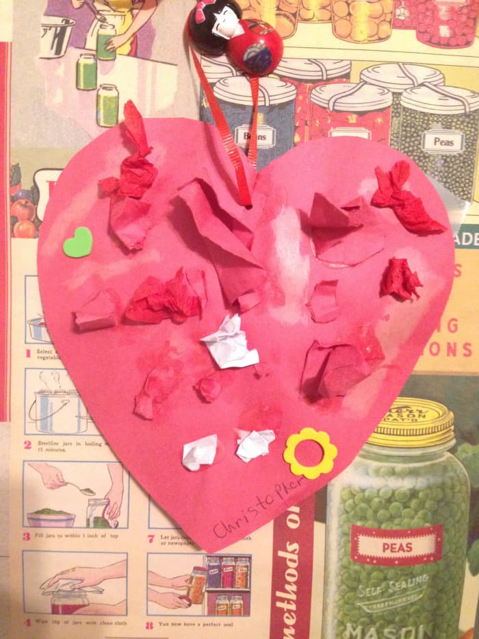 This card was made by cutting out a construction paper heart, painting it with glue, and letting the little one attach paper scraps, tissue paper, and stickers as he wished.