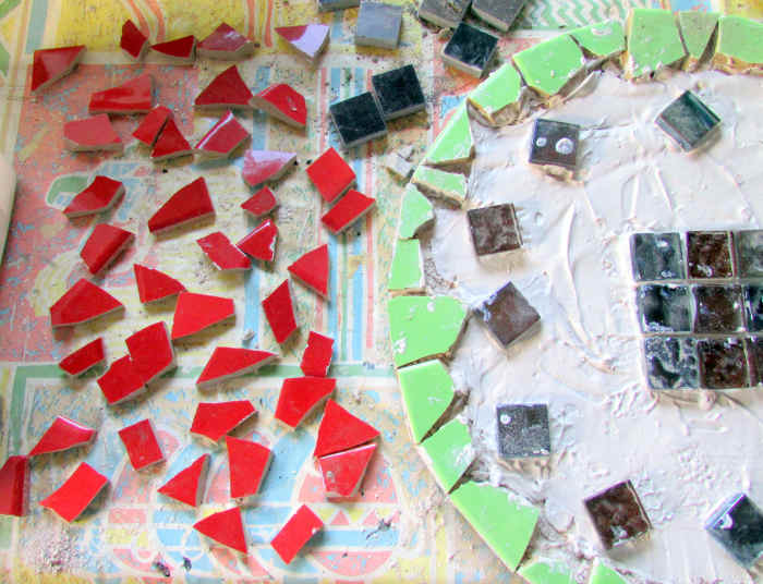 Stick the ceramic tiles onto the board and make your own mosaic design