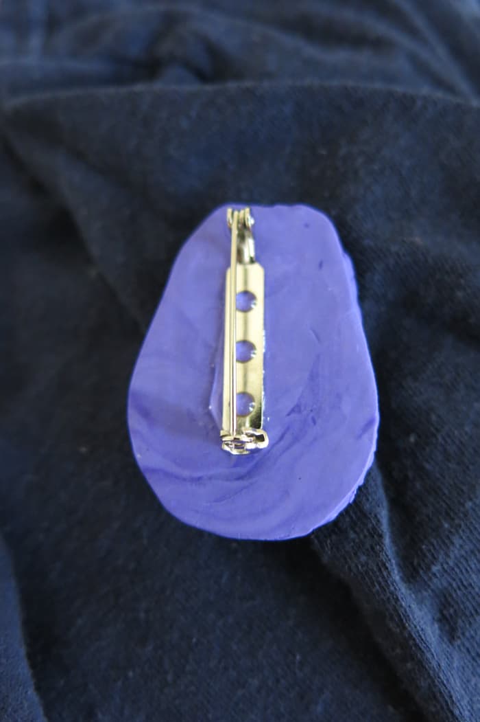 You can use your Matryoshka-style polymer clay dolls to make a colorful pin or brooch.
