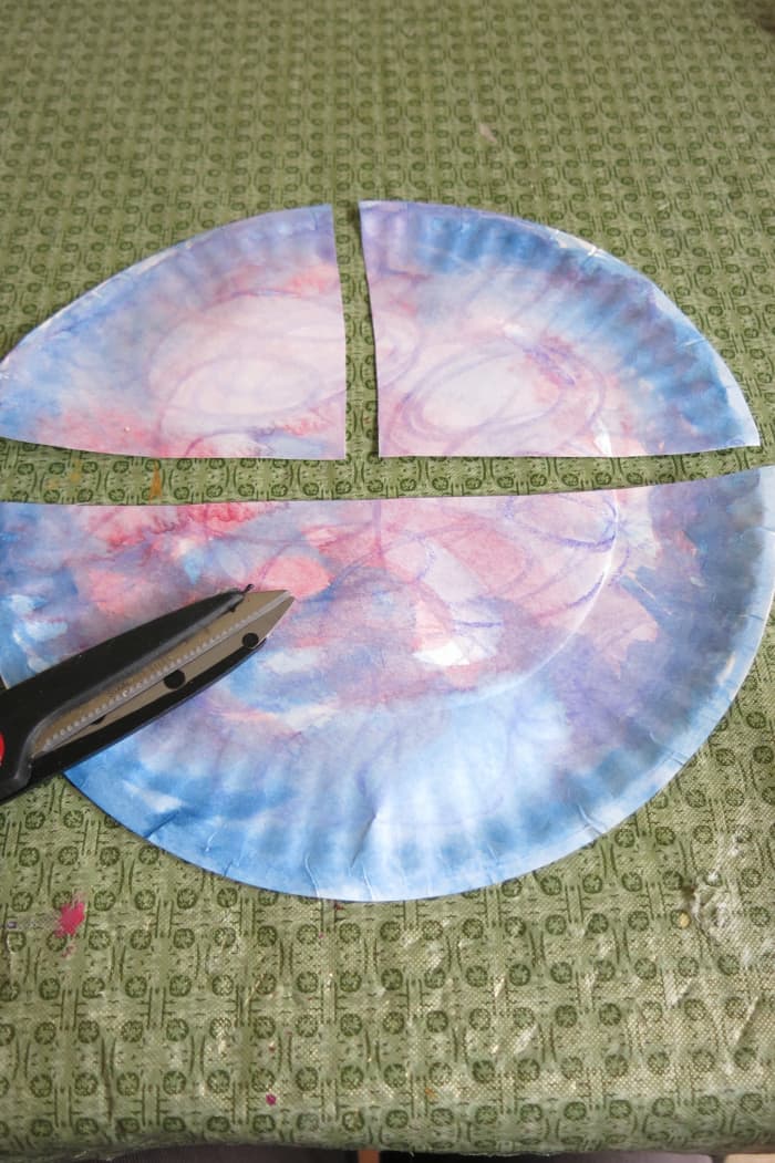 Cut your paper plate into three pieces as shown to start to make the body of your angel.