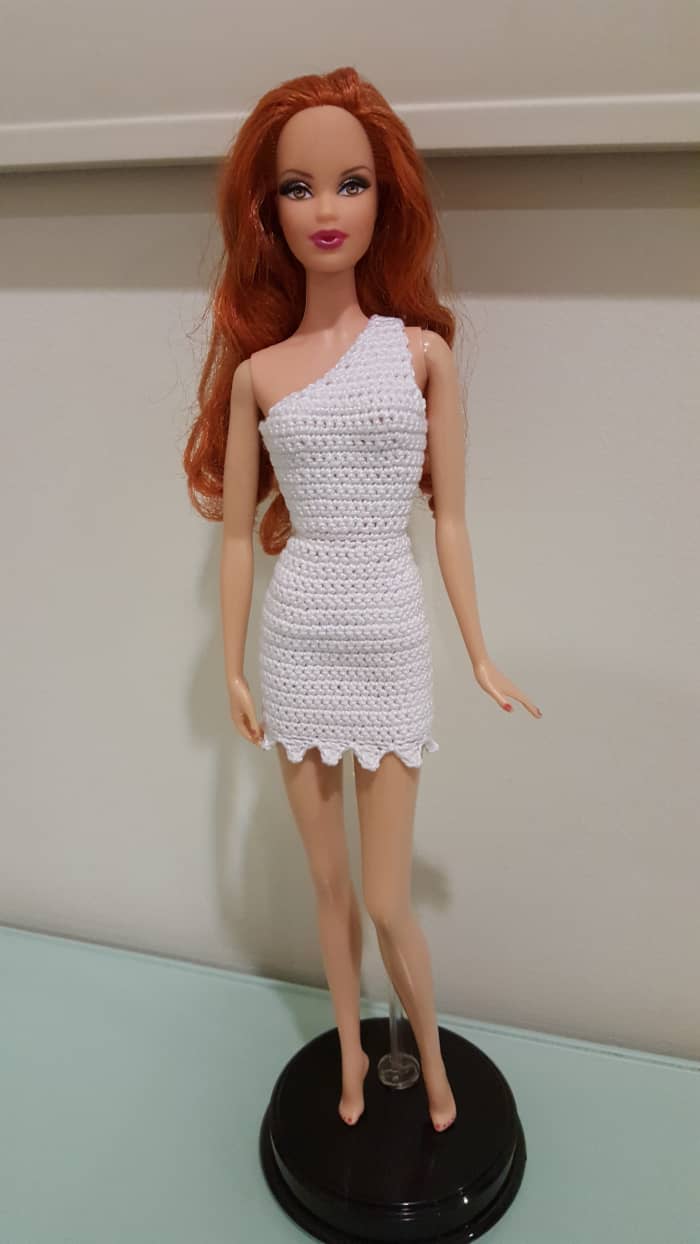 Here's Barbie posing in the completed Wilma Flintstone-style bodycon dress. Learn how to crochet this yourself!