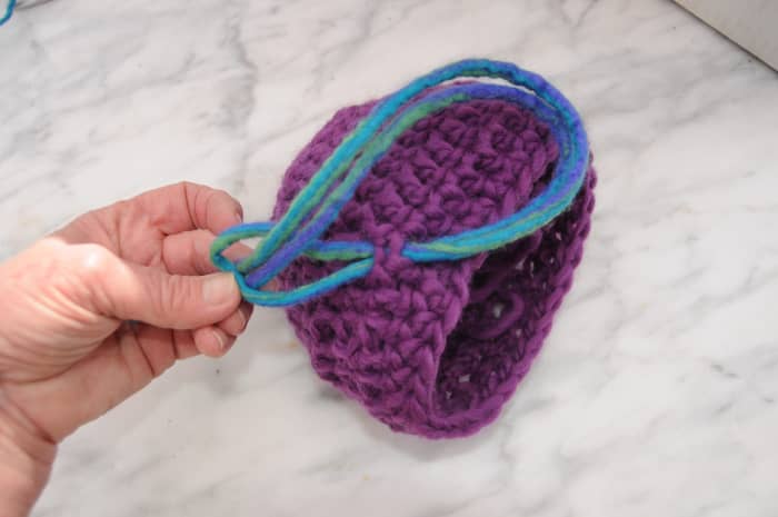 Start at the center front of the hat and weave in the double ended dreads, One dread forms two lengths once knotted against the cap.
