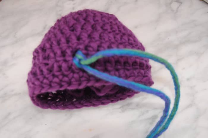 Pulling the ends of the dreads and making the ends firm against the crochet stitches.