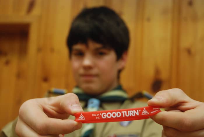 A Scout displays a bracelet to promote Good Turn Week, a time when the organization gives back to the community.