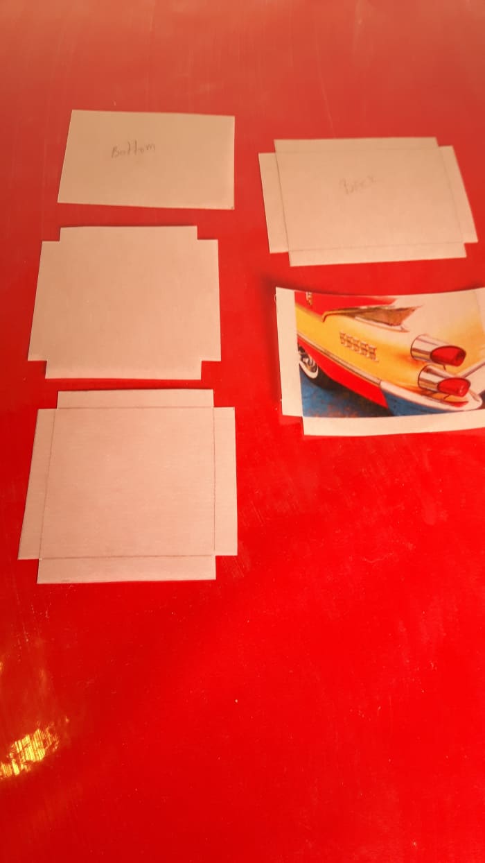 Using a ruler, measure the sides and bottom, then cut them out. Here, the sides and bottom are cut out ready to fold the gluing tabs.