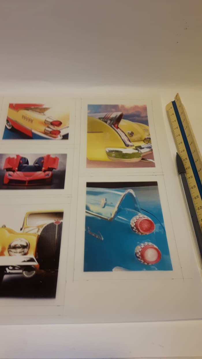 Draw a quarter-inch border around the sides and bottom of each picture. Use a pencil and a ruler to draw the gluing tabs.