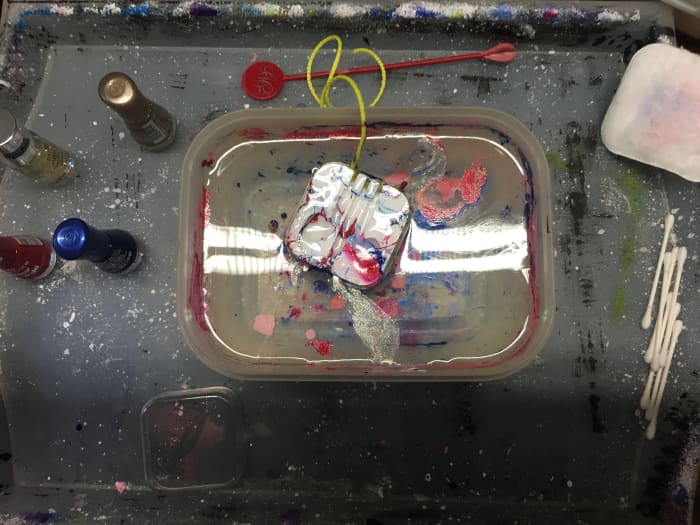 After the headphone case has been dipped into the nail polish, remove the excess with a tooth pick, and hang it up to dry. It's not long before it is done!