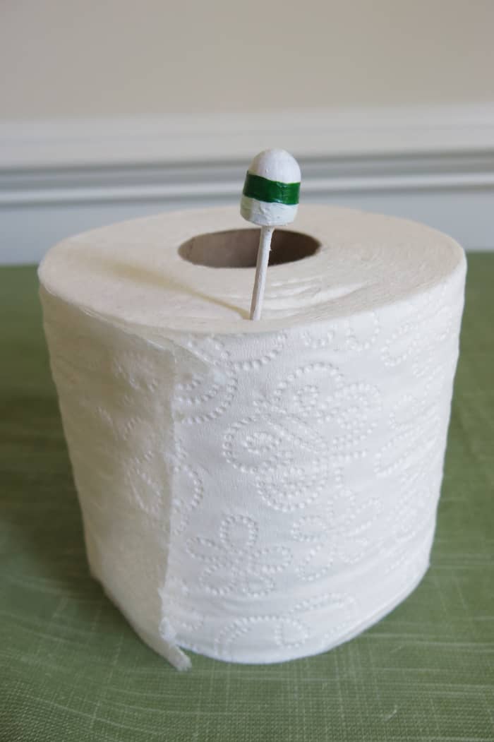 To let dry, place the stick end between the wraps on a roll of toilet paper or paper towels.