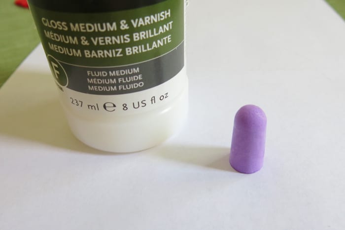 Optional step: Using a paintbrush, coat the sides and rounded end of your earplug with clear acrylic medium or Modge Podge.