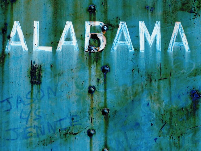 "Alabama." I cannot control my photographic impulses when industrial locations are involved. This old train yard in Calera, Alabama, is a gold mine of imagery just waiting for a camera. This is a photo of a train car, complete with graffiti.